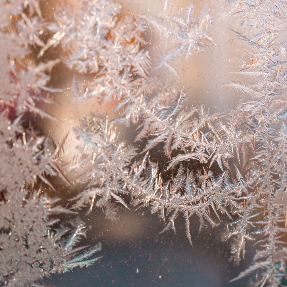 "Snowflake Symmetry" – A macro shot of snowflakes, highlighting their precise, unique fractal formation.